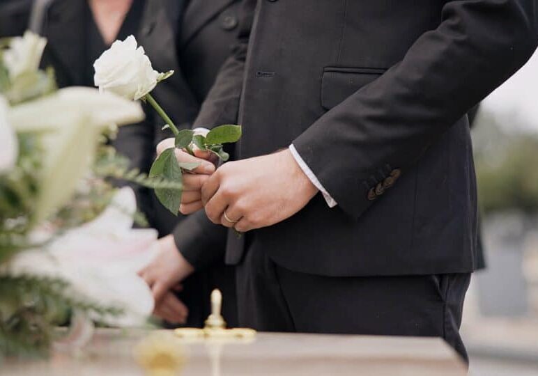 Hand,,Rose,And,A,Person,At,A,Funeral,In,A Best wrongful death lawyer Houston